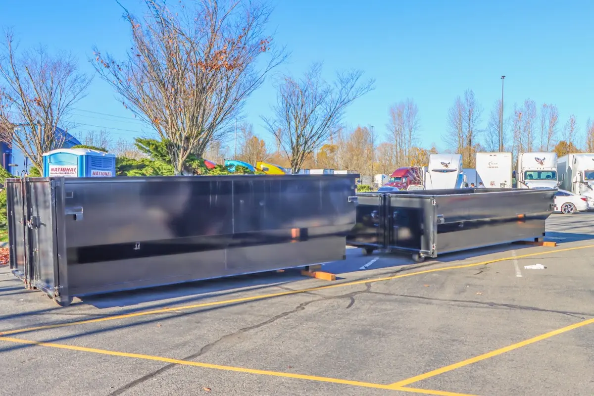 Professional dumpster rental service with roll-off container on residential driveway in Waynesboro